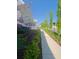 Inviting sidewalk lined with lush landscaping and a charming welcome flag at the house at 89 Little Magnolia Ln, Auburn, GA 30011