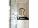 Elegant bathroom featuring a marble shower, floral wallpaper and classic vanity with a beautiful gold mirror at 2479 Peachtree Ne Rd # 1805, Atlanta, GA 30305