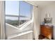 Bedroom with large windows offering city skyline views and featuring a vintage dresser and hardwood flooring at 2479 Peachtree Ne Rd # 1805, Atlanta, GA 30305