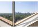 Stunning city skyline view framed by a large triangular window, showcasing lush greenery at 2479 Peachtree Ne Rd # 1805, Atlanta, GA 30305