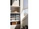 A well organized closet with storage bins, a woven basket and a view out the window at 2479 Peachtree Ne Rd # 1805, Atlanta, GA 30305
