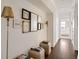 Elegant hallway with hardwood floors, decorative lamps, and framed artwork leading to a bedroom at 2479 Peachtree Ne Rd # 1805, Atlanta, GA 30305