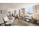 Bright living room featuring hardwood floors, city views, and elegant decor with plush seating at 2479 Peachtree Ne Rd # 1805, Atlanta, GA 30305