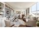 Spacious living area featuring hardwood floors, custom built-ins, and oversized windows with stunning city views at 2479 Peachtree Ne Rd # 1805, Atlanta, GA 30305