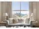Bright living room with skyline views from large windows, comfortable seating, and stylish decor at 2479 Peachtree Ne Rd # 1805, Atlanta, GA 30305