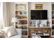 Cozy living room featuring built-in shelving, stylish decor, and hardwood flooring at 2479 Peachtree Ne Rd # 1805, Atlanta, GA 30305