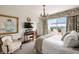 Serene main bedroom featuring a large window, chandelier, and soft, neutral tones at 2479 Peachtree Ne Rd # 1805, Atlanta, GA 30305