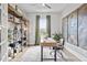 Stylish home office with custom bookshelf, hardwood floors, and abundant natural light at 3547 Cedarvale Ct, Powder Springs, GA 30127