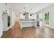 Bright kitchen with white cabinetry, a center island, stainless steel appliances and views to the outdoors at 3975 Clifton Hill Court #7, Cumming, GA 30040