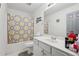 Bathroom featuring a shower-tub combo with a patterned curtain and a white vanity sink at 415 Clairidge Sw Ln, Lawrenceville, GA 30046