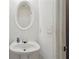 Bathroom featuring a pedestal sink and decorative mirror at 415 Clairidge Sw Ln, Lawrenceville, GA 30046