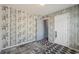 Bedroom featuring carpet floors, patterned walls, and two doors at 415 Clairidge Sw Ln, Lawrenceville, GA 30046