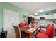 Open-concept dining area featuring views into the kitchen and a long table and ornate chairs at 415 Clairidge Sw Ln, Lawrenceville, GA 30046