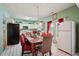 Bright dining area with views into the kitchen, featuring white cabinets and modern appliances at 415 Clairidge Sw Ln, Lawrenceville, GA 30046