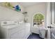 Laundry room featuring white appliances and natural light at 415 Clairidge Sw Ln, Lawrenceville, GA 30046
