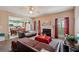Inviting living room with a fireplace, large windows, and an open view to the kitchen and dining area at 415 Clairidge Sw Ln, Lawrenceville, GA 30046