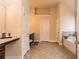 Bright bathroom featuring a separate tub and dark wood cabinets and light tile flooring at 180 Cleburne, Acworth, GA 30101