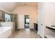 Bright bathroom with separate vanities, walk-in shower, soaking tub, and tile flooring at 180 Cleburne, Acworth, GA 30101
