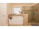 Bathroom featuring a soaking tub and a glass-enclosed shower with beautiful tile work throughout the space at 180 Cleburne, Acworth, GA 30101