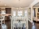 Bright dining area with a chandelier, white table, and dark hardwood floors in an open-concept kitchen layout at 180 Cleburne, Acworth, GA 30101