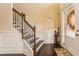 Elegant foyer with hardwood floors, staircase with decorative iron railings, and stylish decorative accents at 180 Cleburne, Acworth, GA 30101