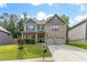 Inviting brick home with a green lawn, a charming covered porch, and a two-car garage at 180 Cleburne, Acworth, GA 30101