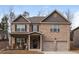 Charming two-story brick home featuring a covered front porch and attached two-car garage at 180 Cleburne, Acworth, GA 30101