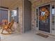 Inviting covered front porch featuring rocking chairs, a seasonal wreath, and stylish brick and siding accents at 180 Cleburne, Acworth, GA 30101