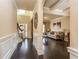 Spacious hallway with dark wood floors connecting to a living room, enhanced by wainscoting and arched entryways at 180 Cleburne, Acworth, GA 30101