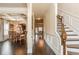 Inviting hallway featuring dark wood floors, wainscoting, and connections to dining and living spaces, ideal for entertaining at 180 Cleburne, Acworth, GA 30101