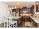 Beautiful kitchen with dark cabinetry, stainless steel appliances, granite countertops, and an island with seating at 180 Cleburne, Acworth, GA 30101