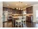 Bright kitchen with stainless steel appliances, granite island, dark cabinets, and hardwood floor at 180 Cleburne, Acworth, GA 30101