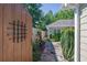 Landscaped backyard with wooden gate leading to an enclosed garden area, offering privacy and charm at 308 Jessica Way, Canton, GA 30114