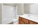 Bathroom featuring white fixtures including a tub-shower and vanity with wood cabinetry at 308 Jessica Way, Canton, GA 30114