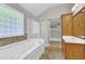 Bathroom featuring a tub, glass-block window, and shower at 308 Jessica Way, Canton, GA 30114