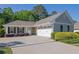 Charming home featuring a manicured lawn, attached garage, and a welcoming entrance at 308 Jessica Way, Canton, GA 30114