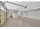Spacious garage with epoxy floor and ample room for vehicles and storage, along with interior access door at 308 Jessica Way, Canton, GA 30114