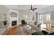 Bright living room featuring a fireplace, ceiling fan, and neutral decor at 308 Jessica Way, Canton, GA 30114