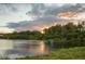 Scenic community pond surrounded by lush greenery reflecting a dramatic sunset sky at 308 Jessica Way, Canton, GA 30114
