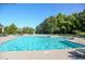 Large community pool with clear blue water, lounge chairs, and umbrellas at 308 Jessica Way, Canton, GA 30114