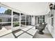 Cozy sunroom featuring wicker furniture, screened walls, and natural light with views of the backyard at 308 Jessica Way, Canton, GA 30114