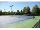 Outdoor tennis court with well-maintained surface, net, and fencing at 308 Jessica Way, Canton, GA 30114