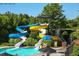 Community pool with fun and colorful water slides surrounded by lush greenery at 308 Jessica Way, Canton, GA 30114