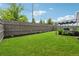 Spacious backyard with lush green grass, wood fence and patio with pergola at 3638 Silvery Way, Powder Springs, GA 30127