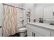 Clean bathroom featuring a tub with a shower, modern fixtures, and stylish decor at 3638 Silvery Way, Powder Springs, GA 30127