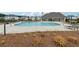 Community pool with lounge chairs, umbrellas, and a covered pavilion on a sunny day at 3638 Silvery Way, Powder Springs, GA 30127