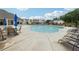 A large community pool with lounge chairs and umbrellas on a sunny day at 3638 Silvery Way, Powder Springs, GA 30127