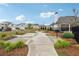 A manicured walkway in a residential community with well maintained landscaping and beautiful, craftsman style homes at 3638 Silvery Way, Powder Springs, GA 30127