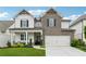 Charming two-story home featuring a brick facade, a well-maintained lawn, and a two-car garage at 3638 Silvery Way, Powder Springs, GA 30127