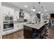 Modern kitchen with white cabinets, stainless steel appliances, and island seating at 3638 Silvery Way, Powder Springs, GA 30127